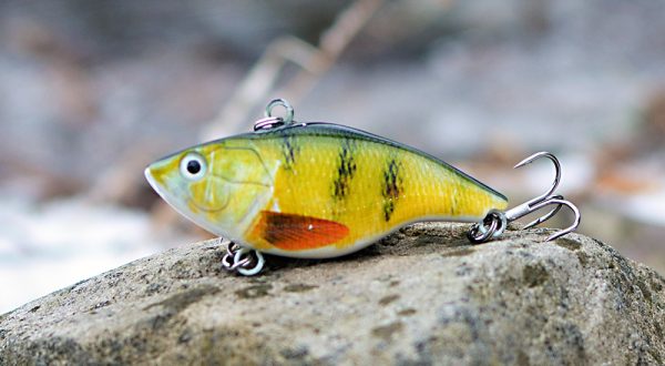 bass green yellow crankbait on a stone