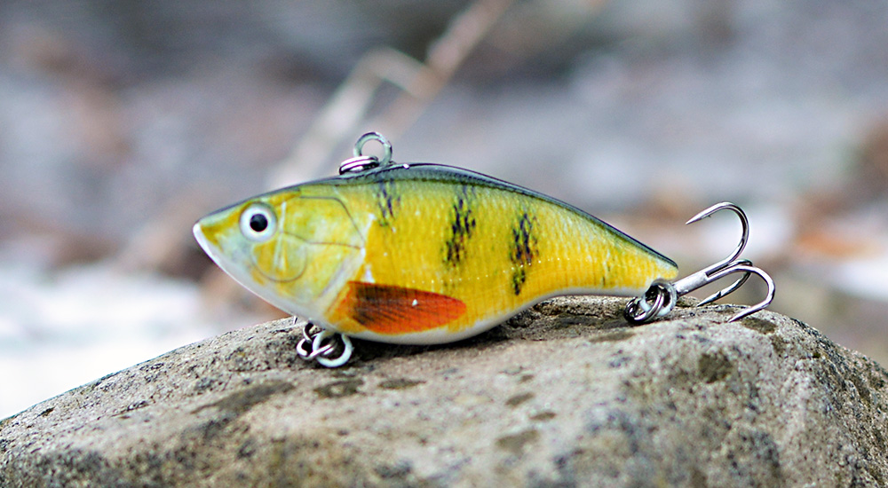 bass yellow green looking crankbait on a rock